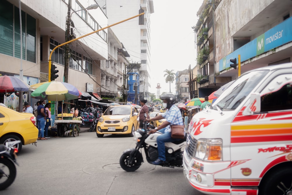 a person riding a motorcycle down a busy street