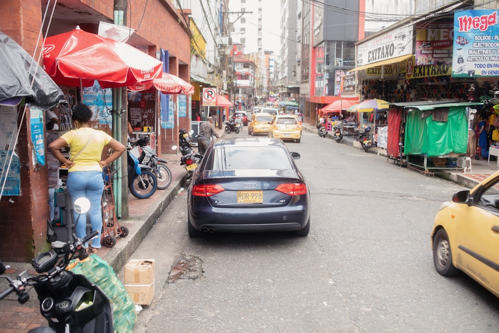 a busy street with cars and people