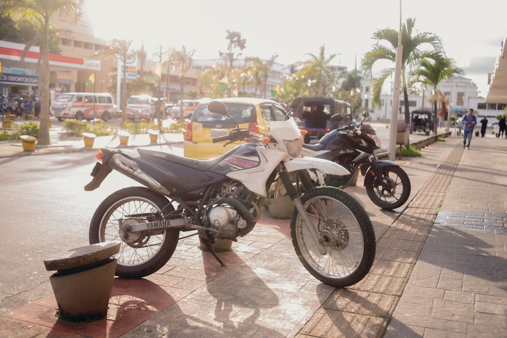 motorcycles parked on the sidewalk