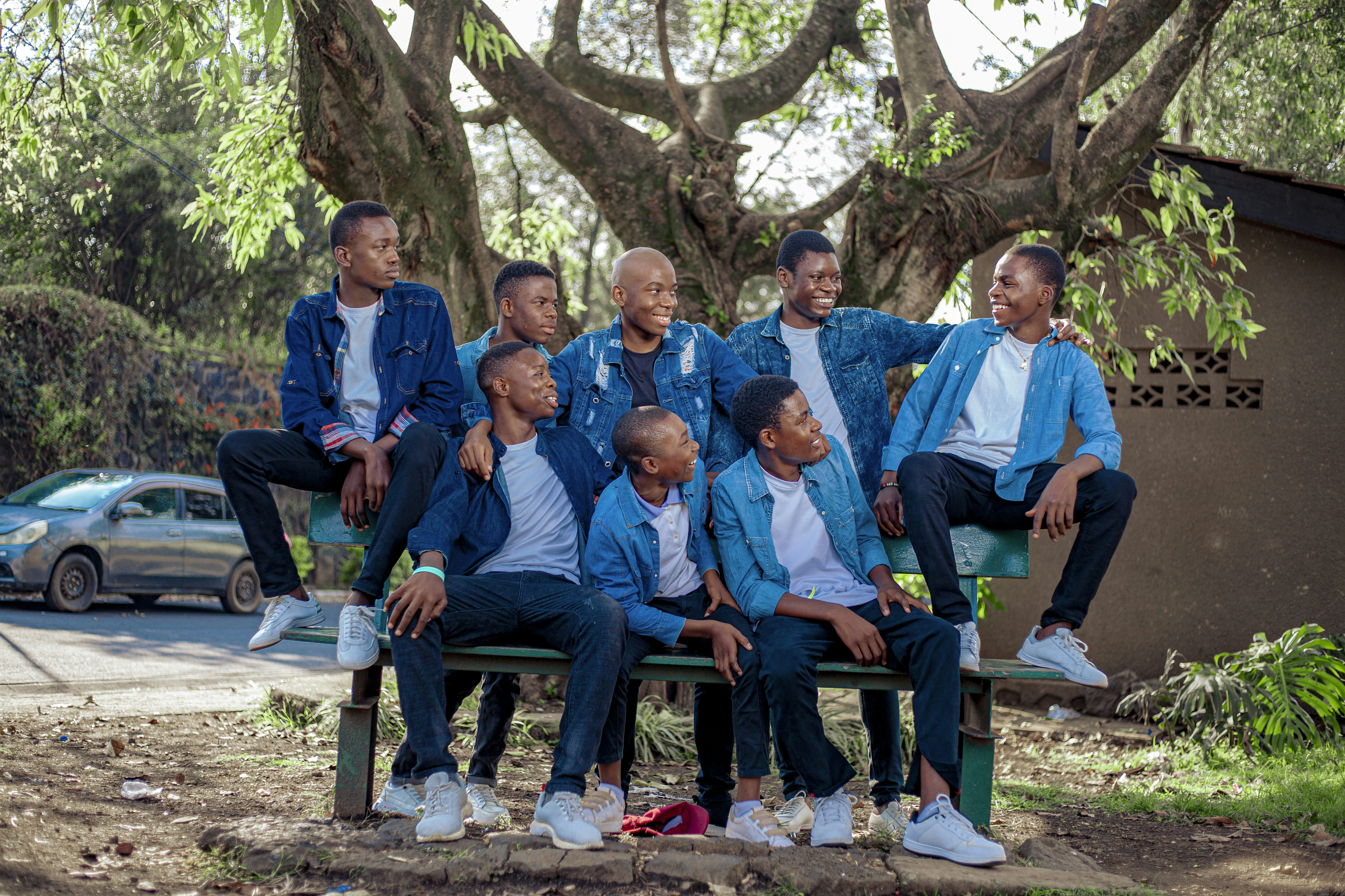 a group of men sitting on a bench