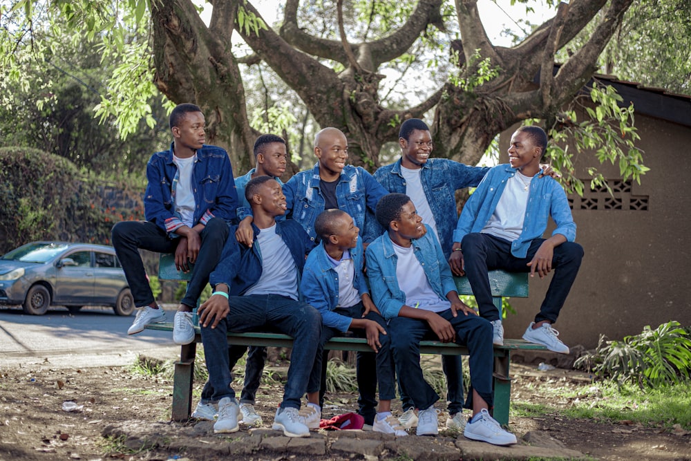 a group of men sitting on a bench