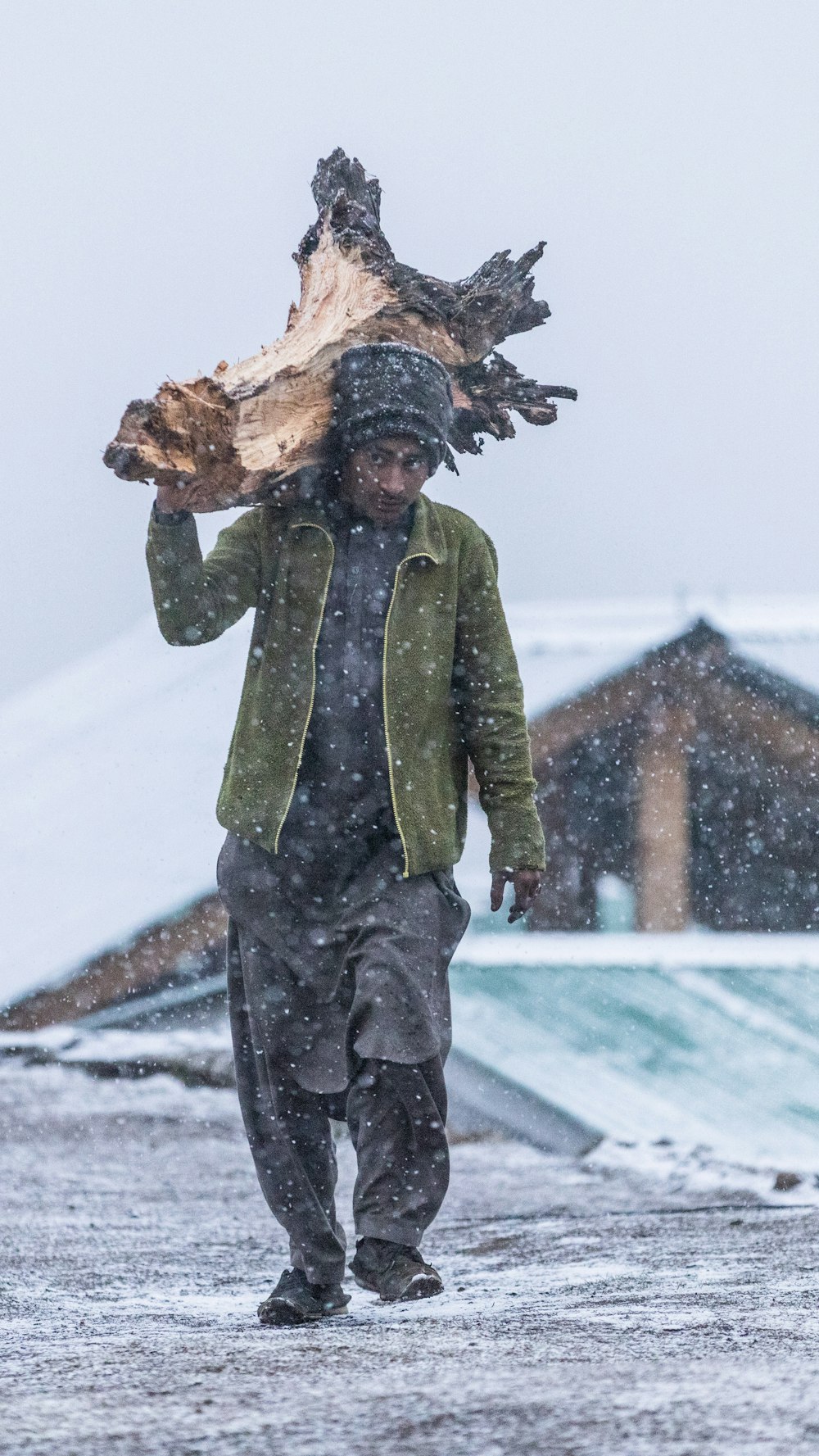 a man carrying a large bird on his back