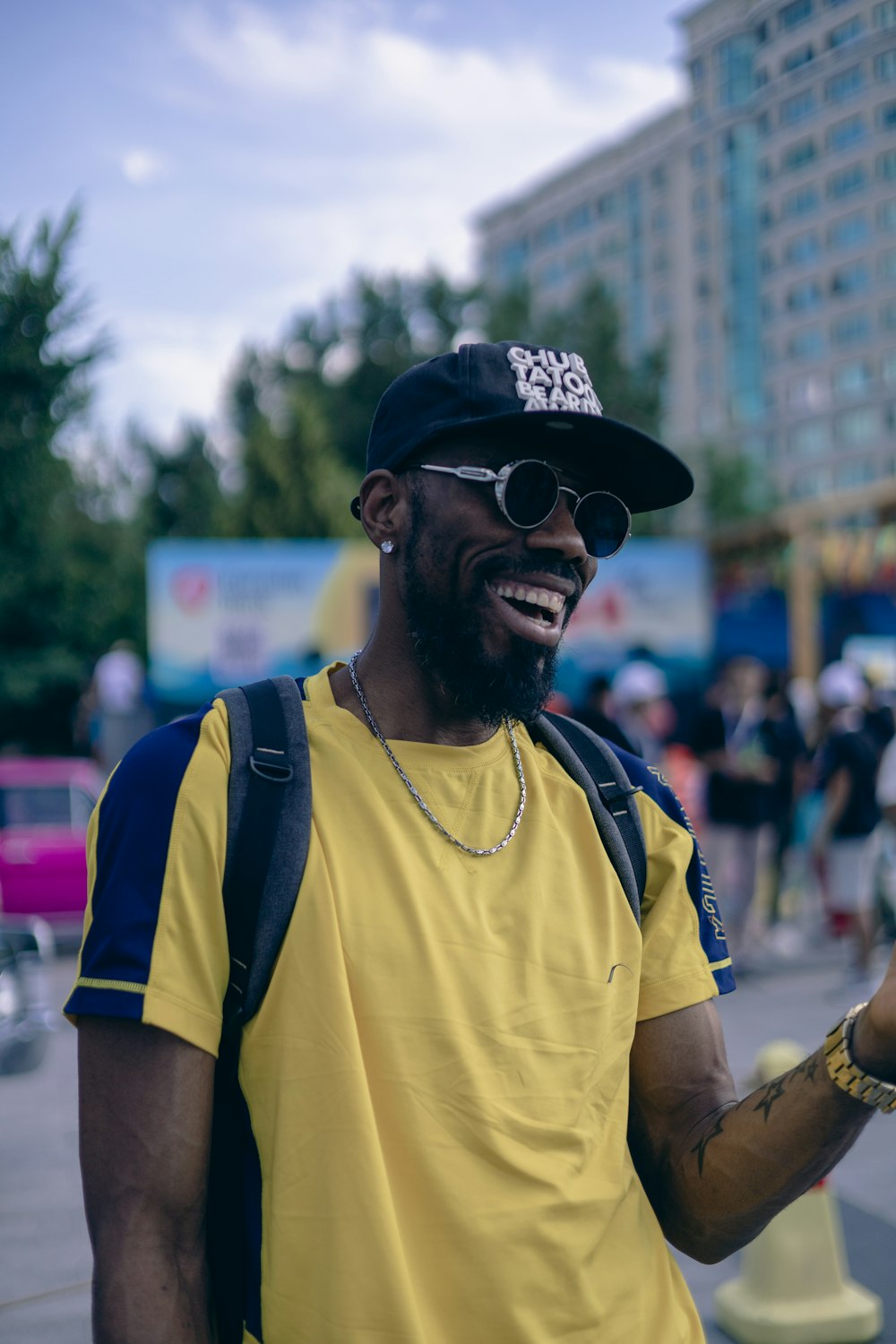 a man wearing a hat and sunglasses