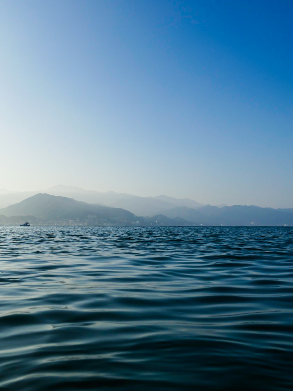 a body of water with mountains in the background