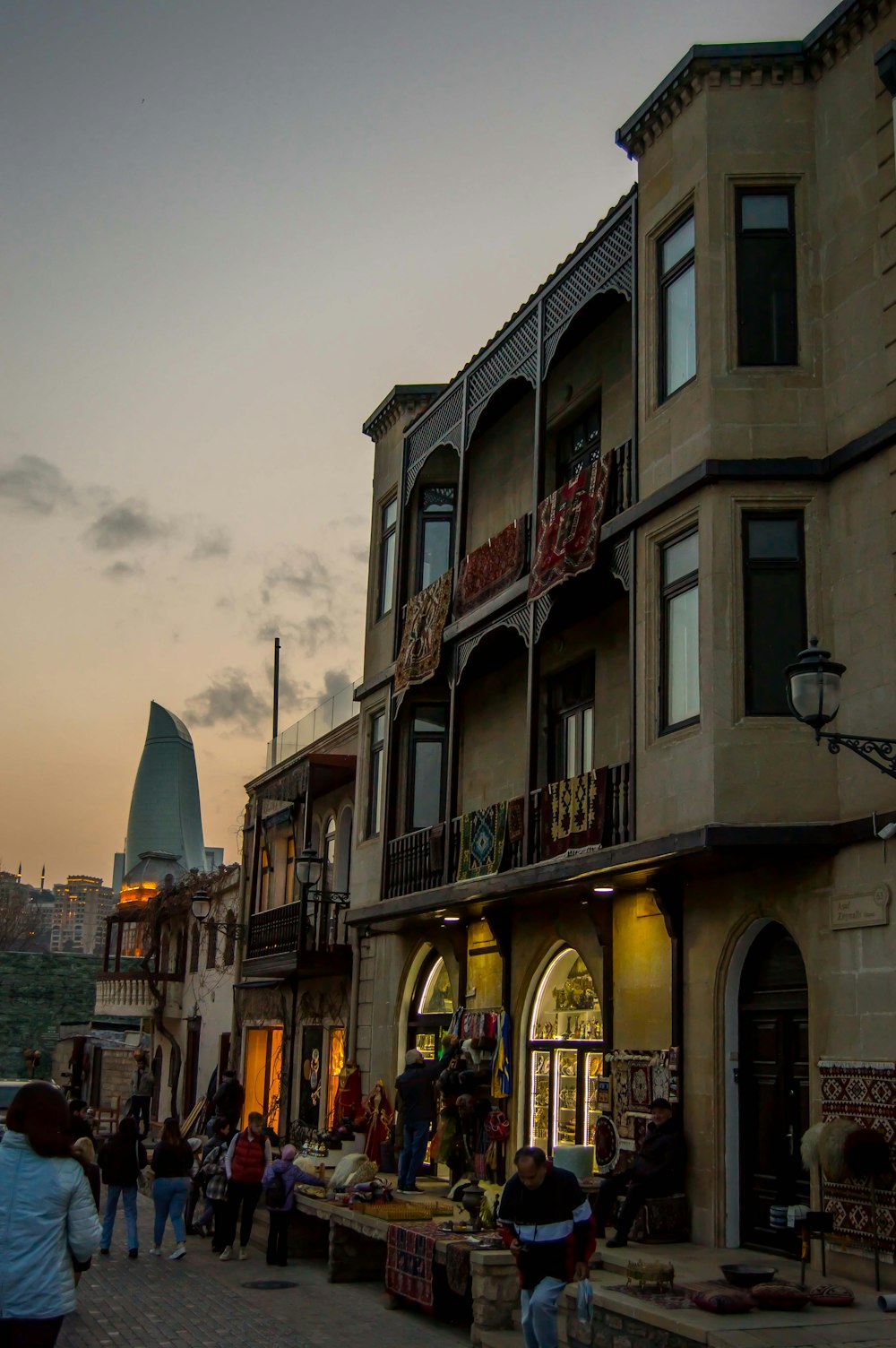 a group of people walking on a street between buildings