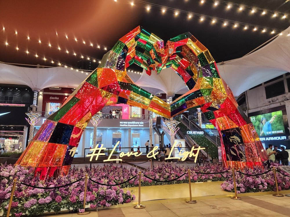 a large colorful building with a large display of flowers