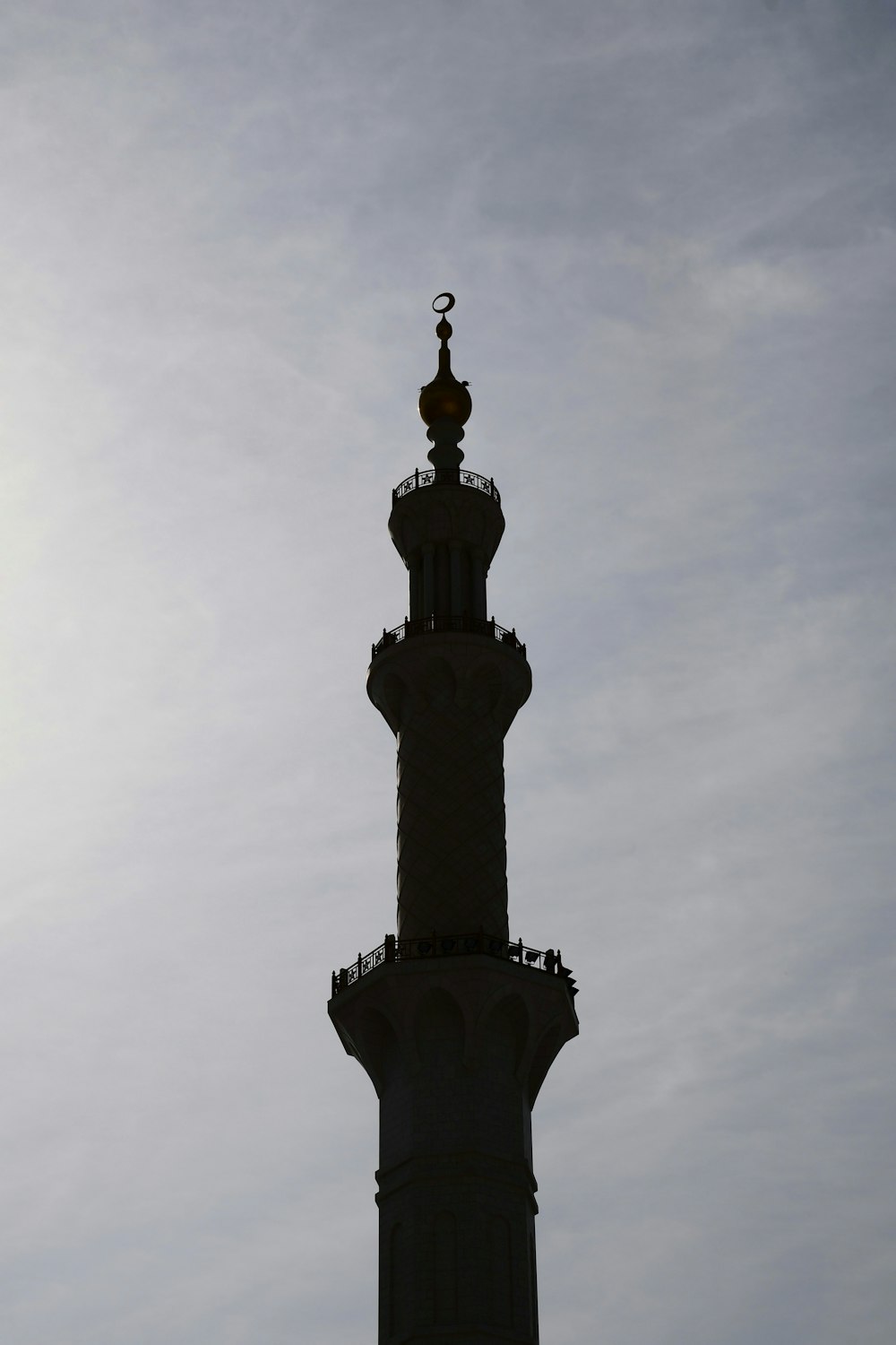 a tall tower with a statue on top