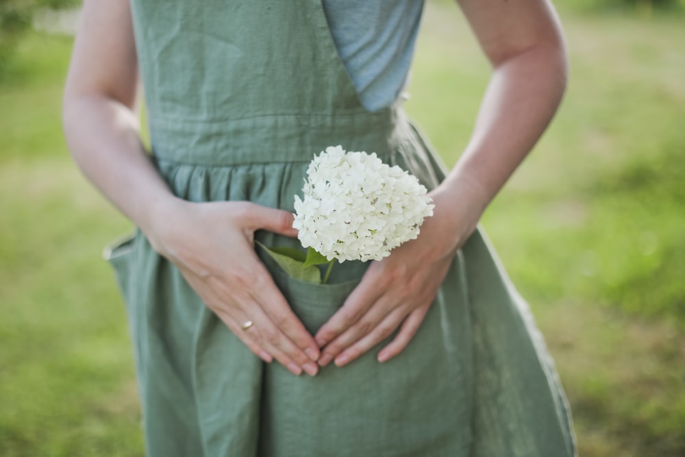 a person holding a white flower