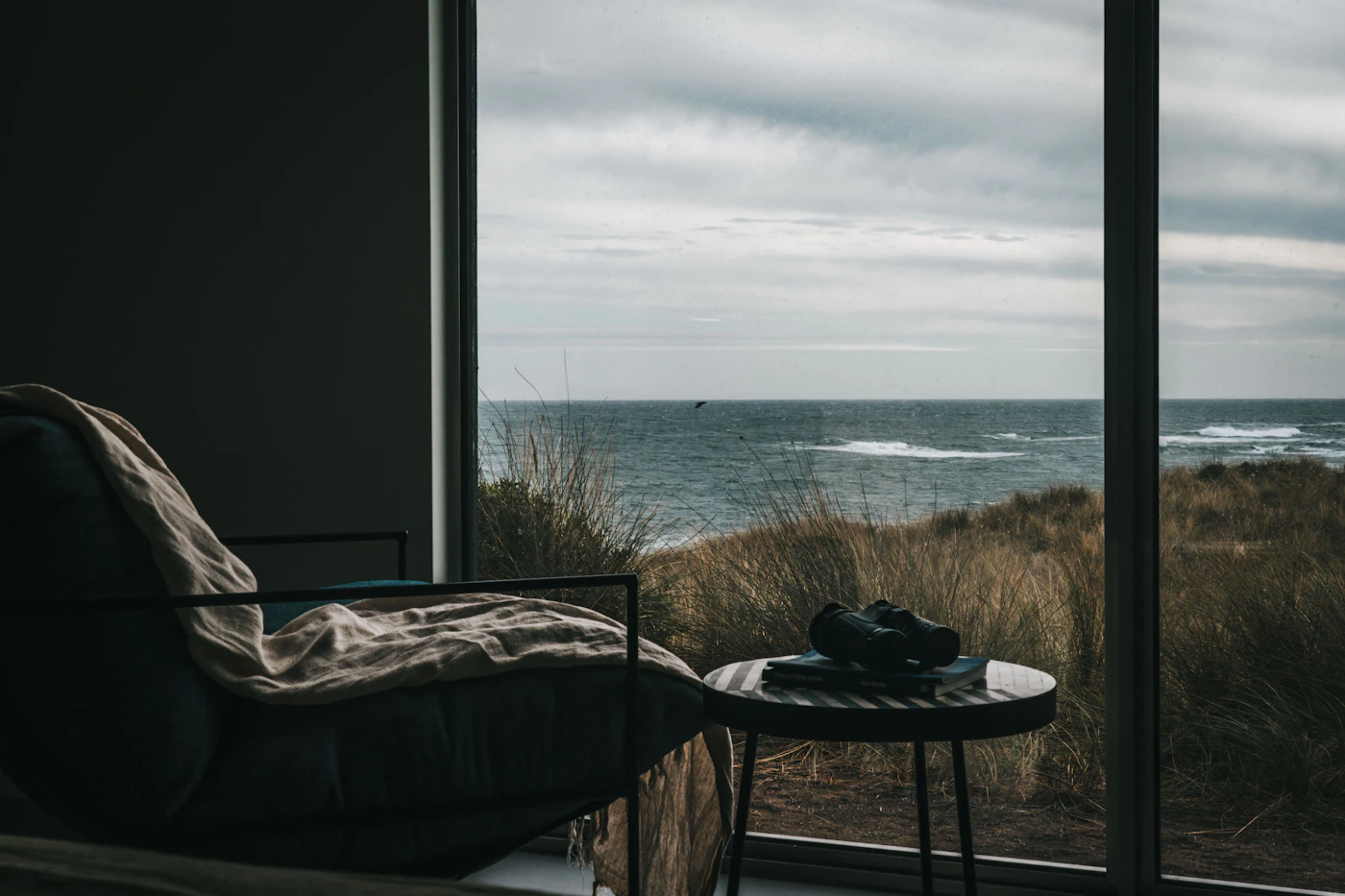 Table and chair by a window overlooking the ocean
