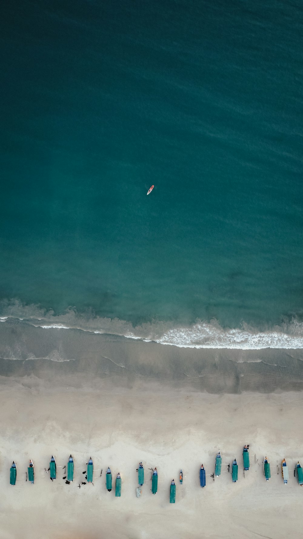 a group of blue bottles on a beach