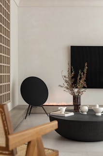 A minimalist living room featuring a stylish speaker blending seamlessly with the decor.