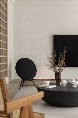 A minimalist living room featuring a stylish speaker blending seamlessly with the decor.