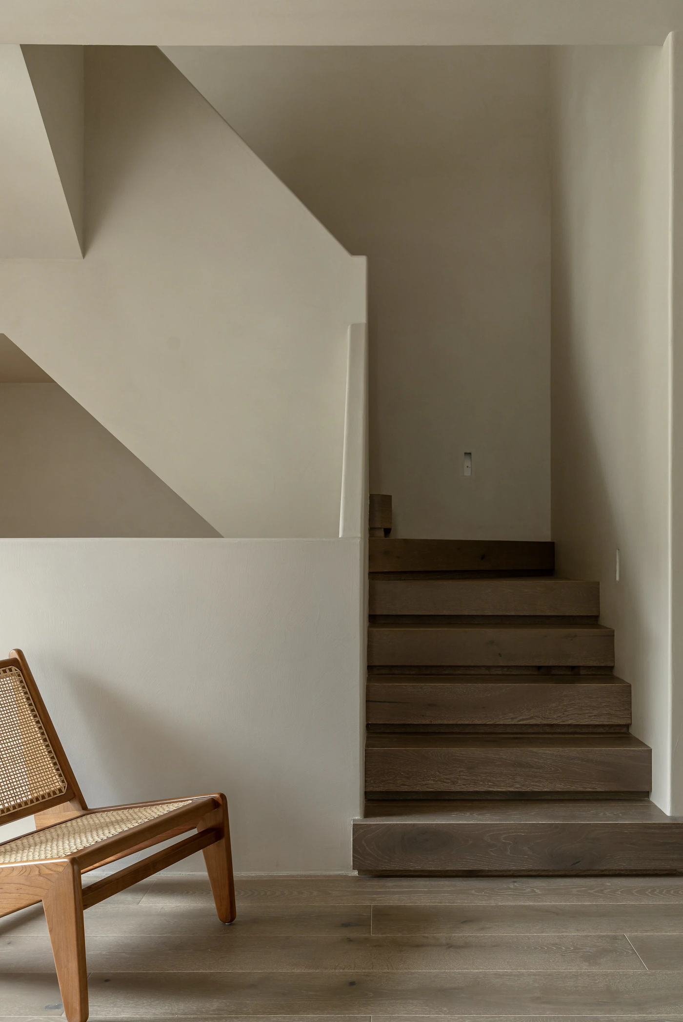Warm minimalist staircase with natural wood chair