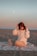a woman sitting on a beach