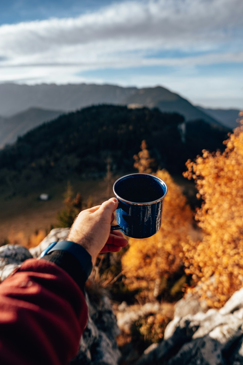 a person holding a cup of coffee