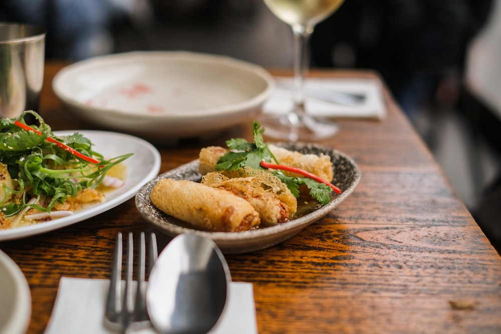 a table with plates of food and silverware