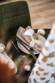 Close-up of elegant bagasse tableware arranged on a warm beige linen cloth, highlighting texture and craftsmanship.