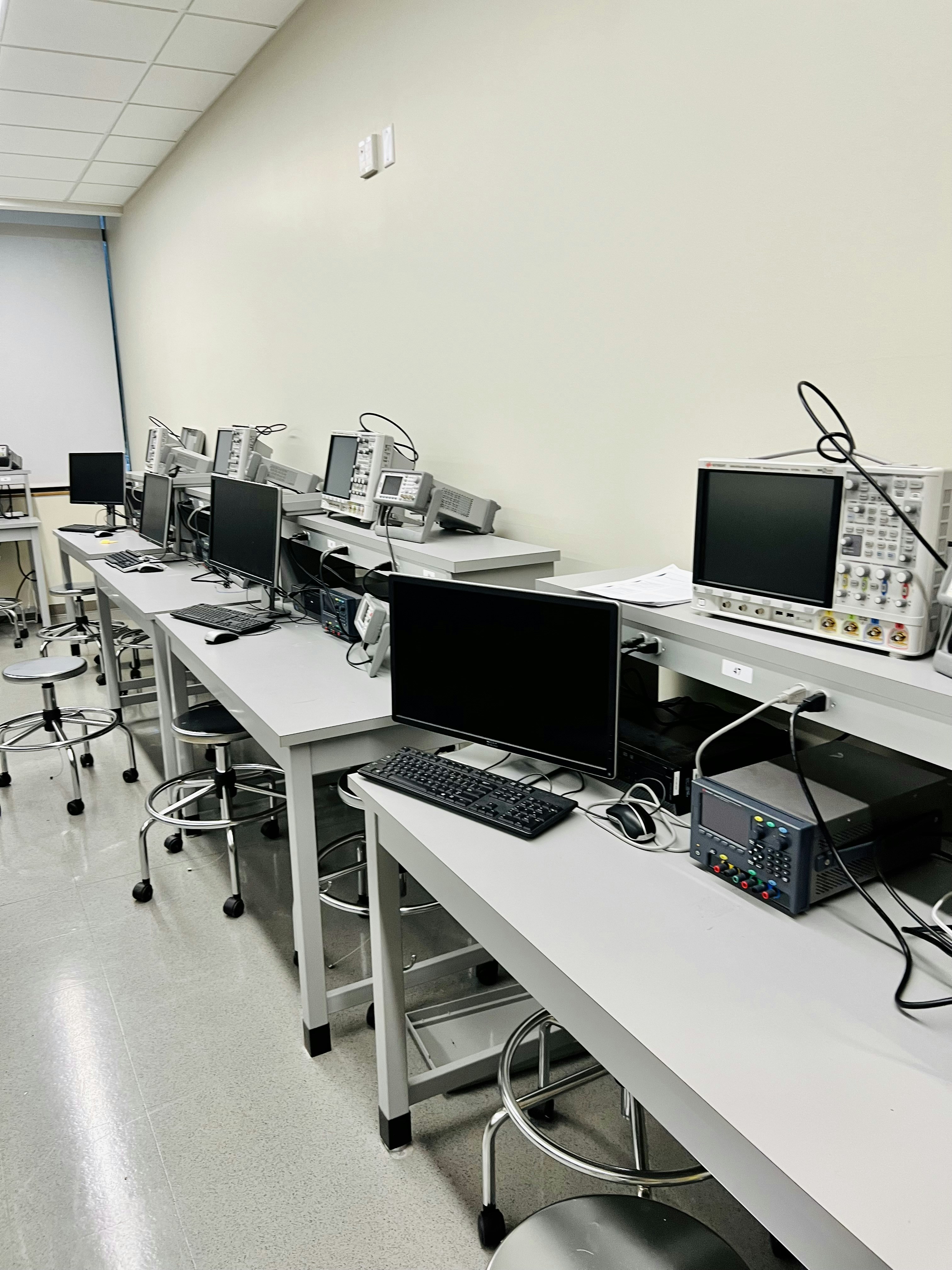 Professional electronics testing laboratory with measurement equipment and organized workstations for product evaluation
