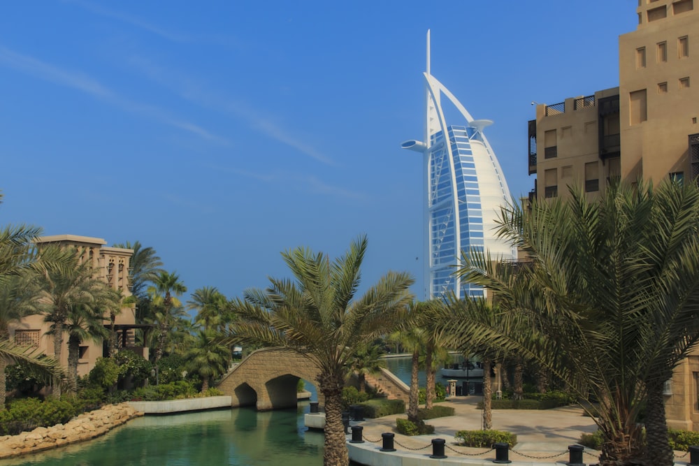 a tall building with a bridge over a body of water