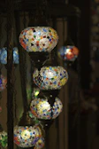 Handmade Turkish mosaic art pieces illuminated softly, showcasing detailed craftsmanship.
