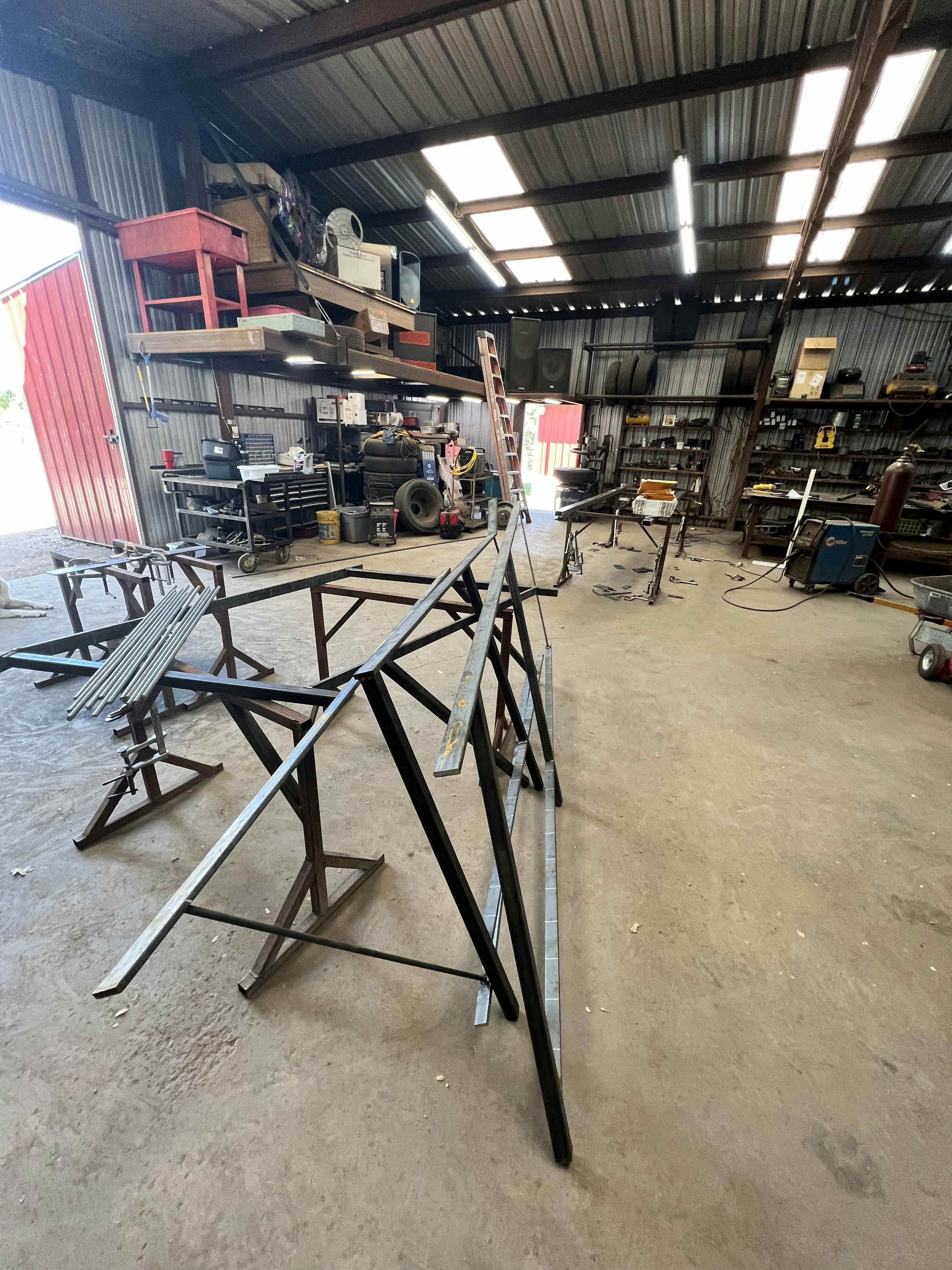 Metal fabrication workshop with steel plates and precision cutting equipment, bright workshop lighting on metal surfaces