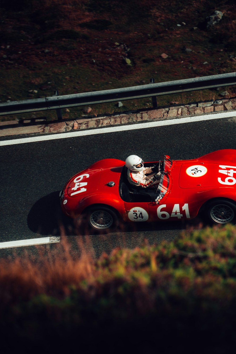 a person driving a red car