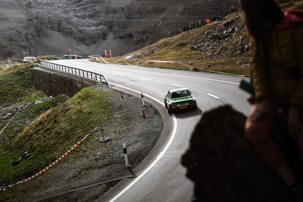 a green car on a road