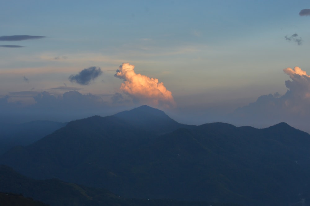 a mountain range with clouds