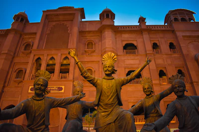 a group of statues in front of a building