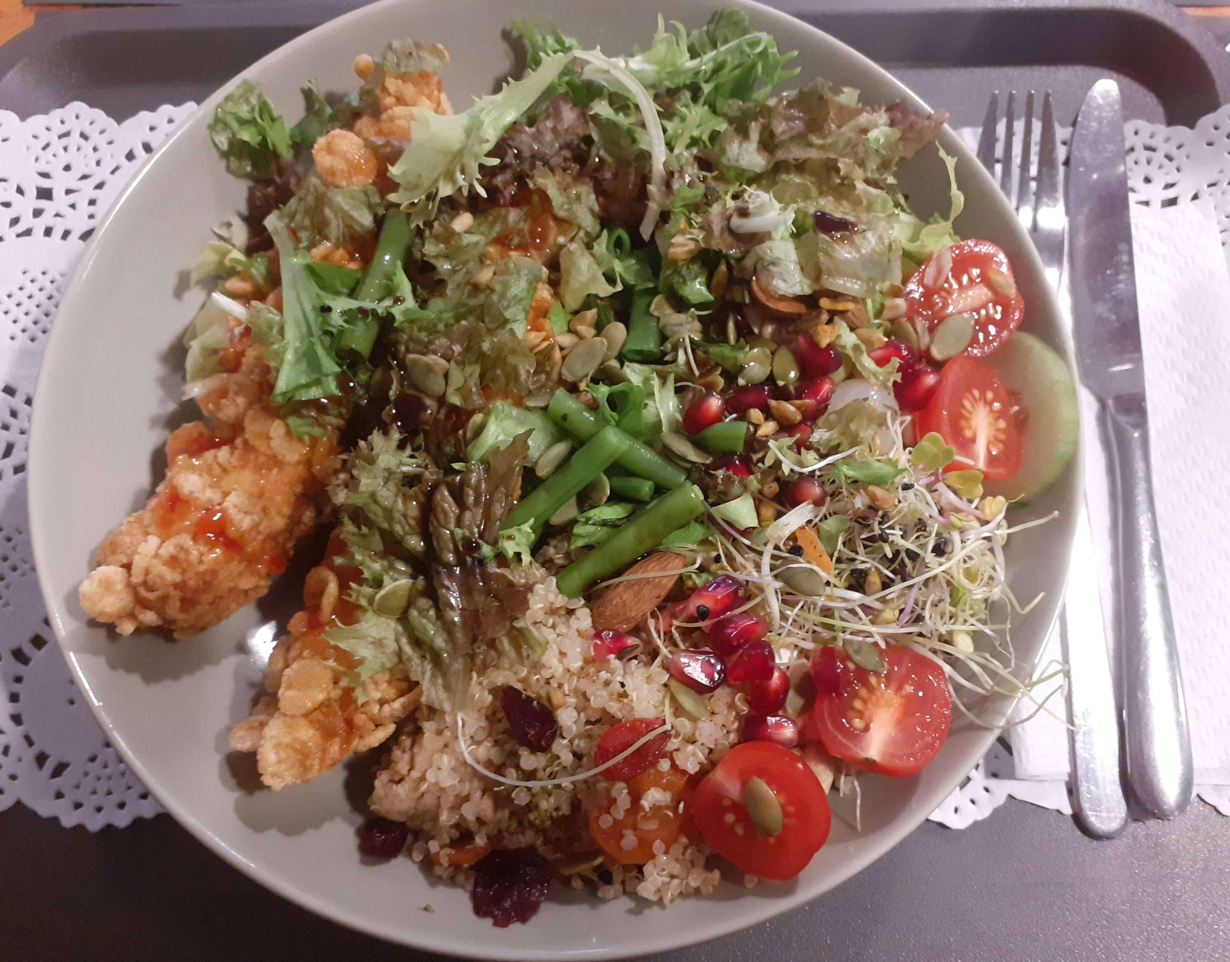 Fresh chicken salad with green leaves, cherry tomatoes, and citrus dressing