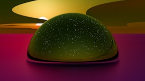 A large, dome-like structure with a reflective surface appears in the center, resembling a starry sky. The background features a vibrant sunset with shades of orange, yellow, and pink merging seamlessly. There is a serene and surreal atmosphere created by the soft blending of colors and celestial elements.