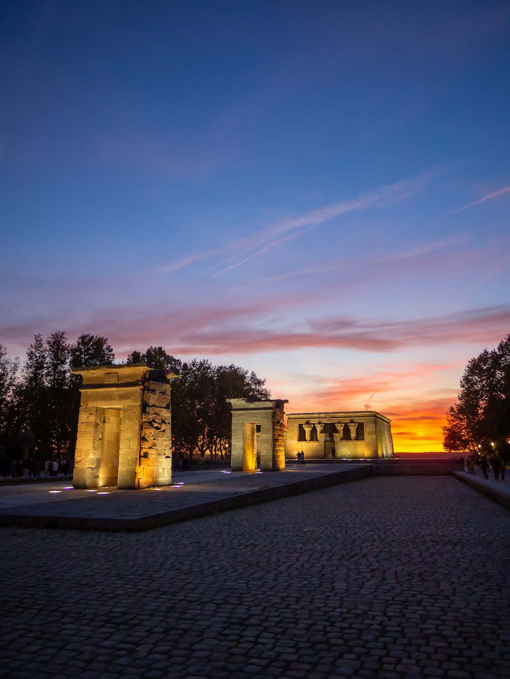 un bâtiment avec un coucher de soleil en arrière-plan