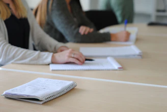a person writing on a piece of paper