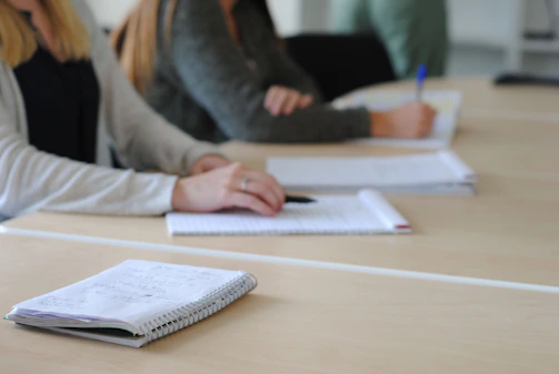 a person writing on a piece of paper