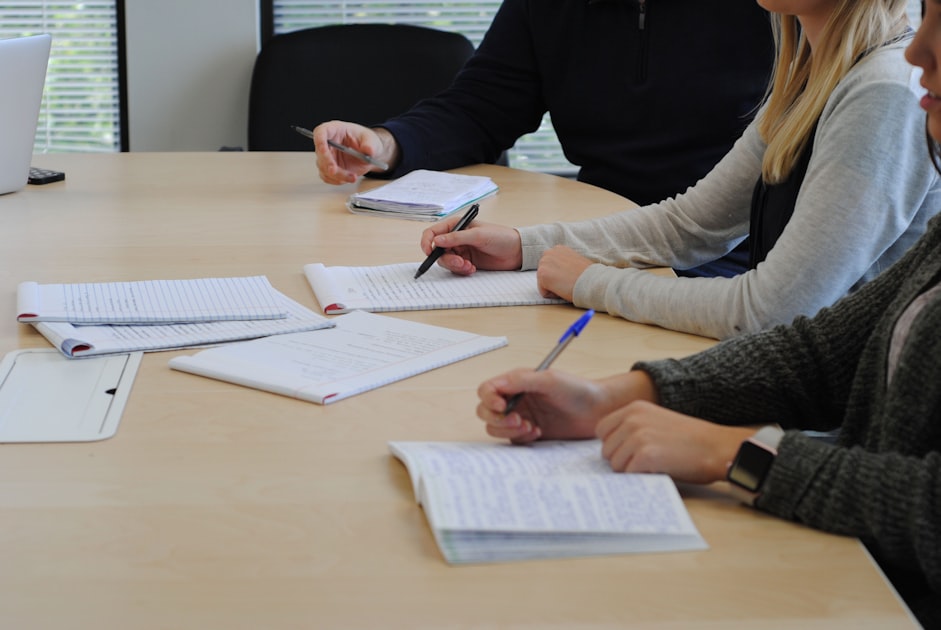 Two people reviewing and signing a rental agreement document at a desk, representing tenant document verification for HCMC apartments