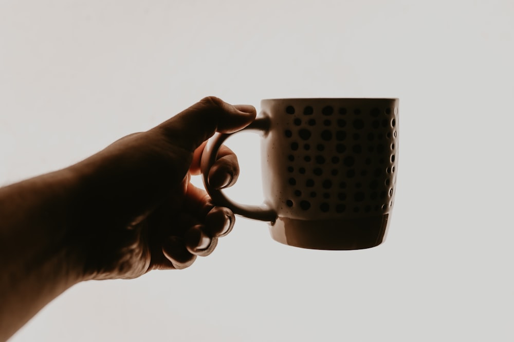 a hand holding a metal object