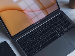 Close-up of a laptop displaying an email inbox with a message from Halo BCA Bisnis support