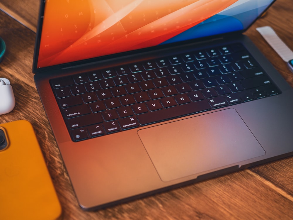 a laptop with a rainbow logo