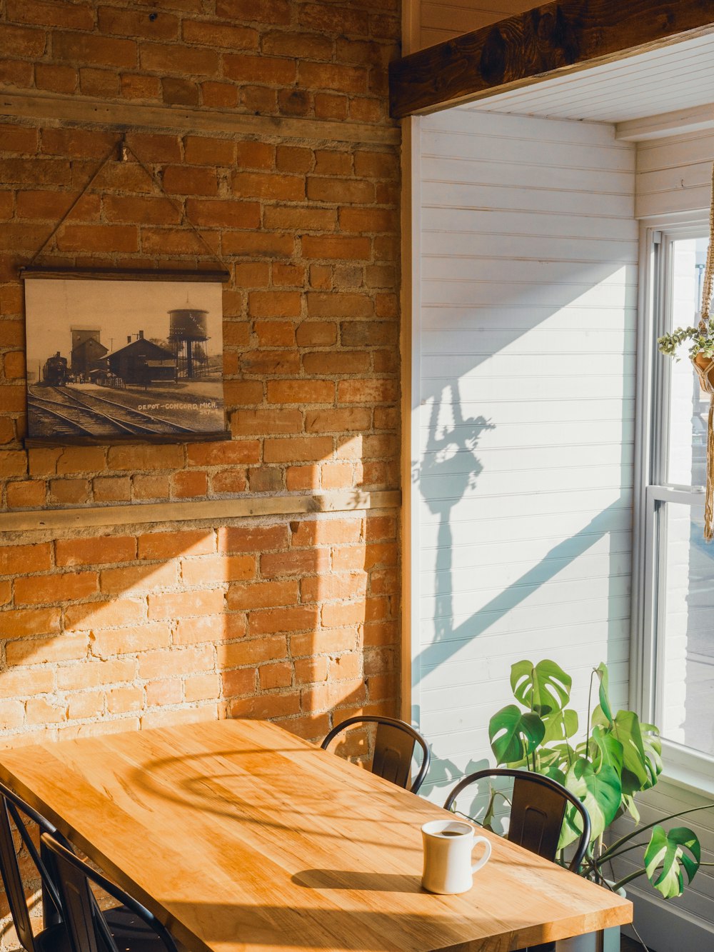 a table with a cup on it by a window