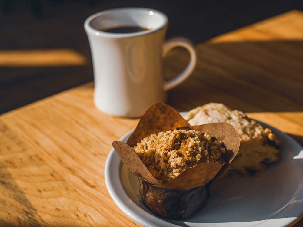 a cup of coffee next to a plate of food