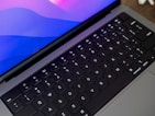 A close-up of hands typing on a sleek keyboard.