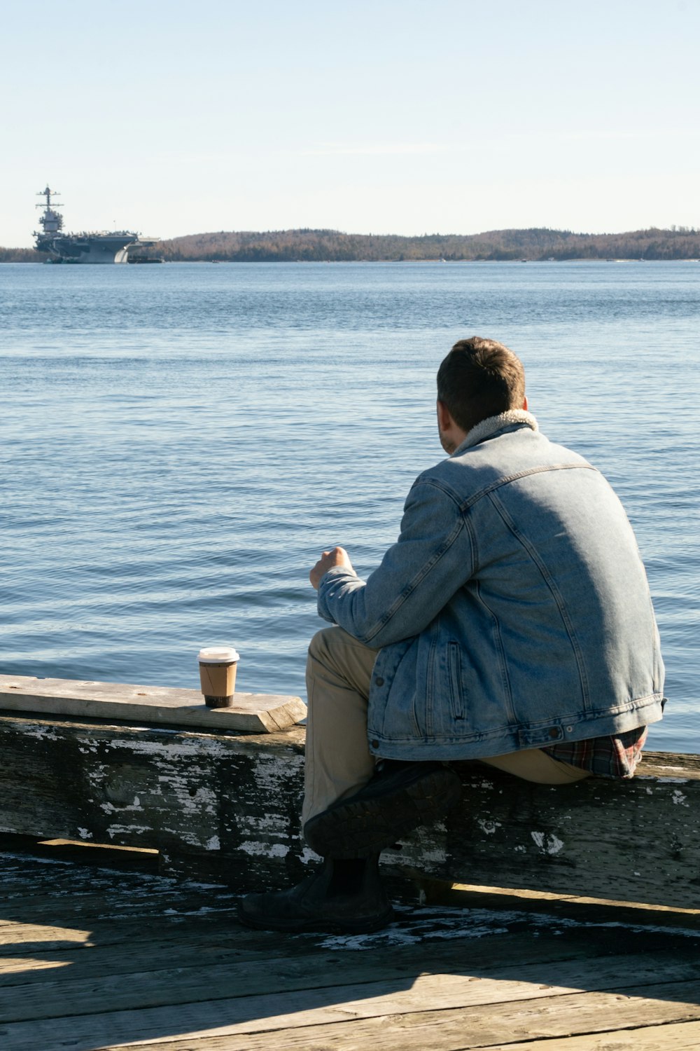 a man sitting on a dock