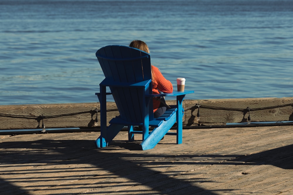 a person sitting in a chair on a beach