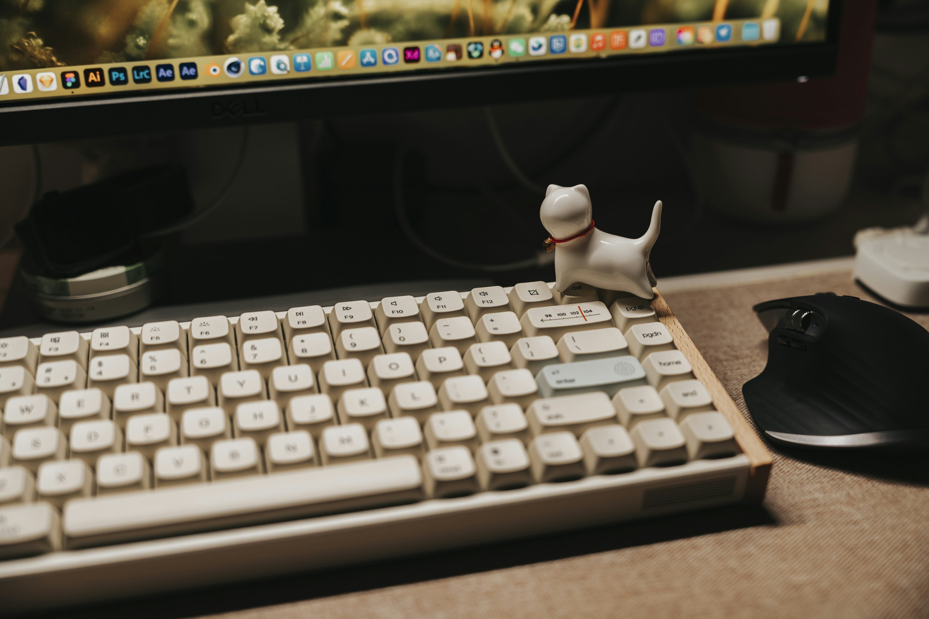 a white keyboard sits in front of a computer monitor