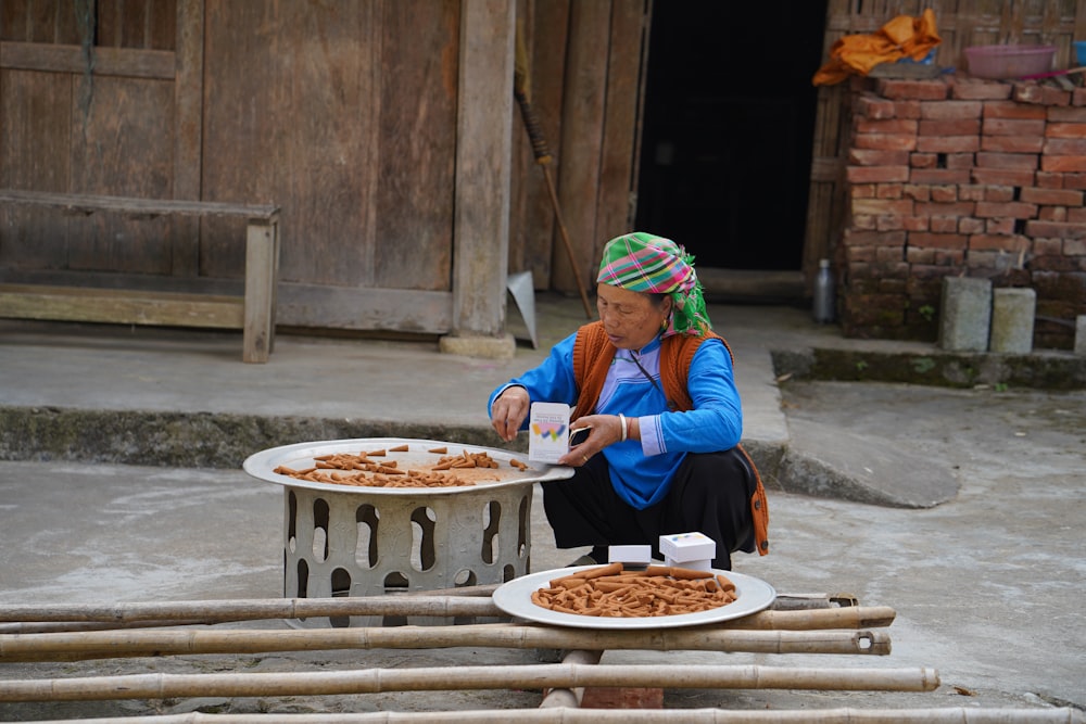 a person sitting outside with a plate of food