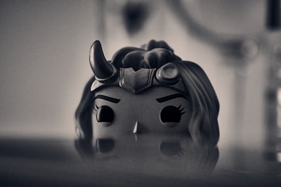 Close-up of a fierce heroine with expressive eyes and intricate costume details.