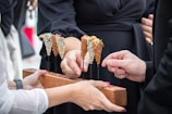 a group of hands holding a piece of wood