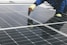 a person working on a solar panel