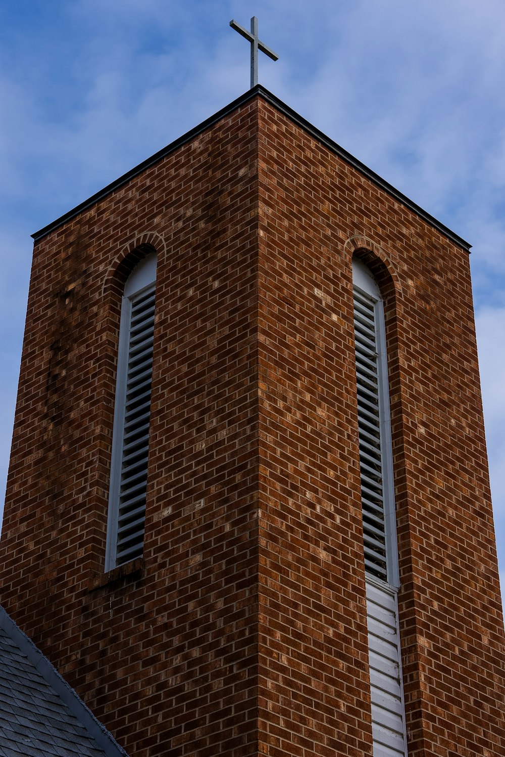a brick building with a cross on top