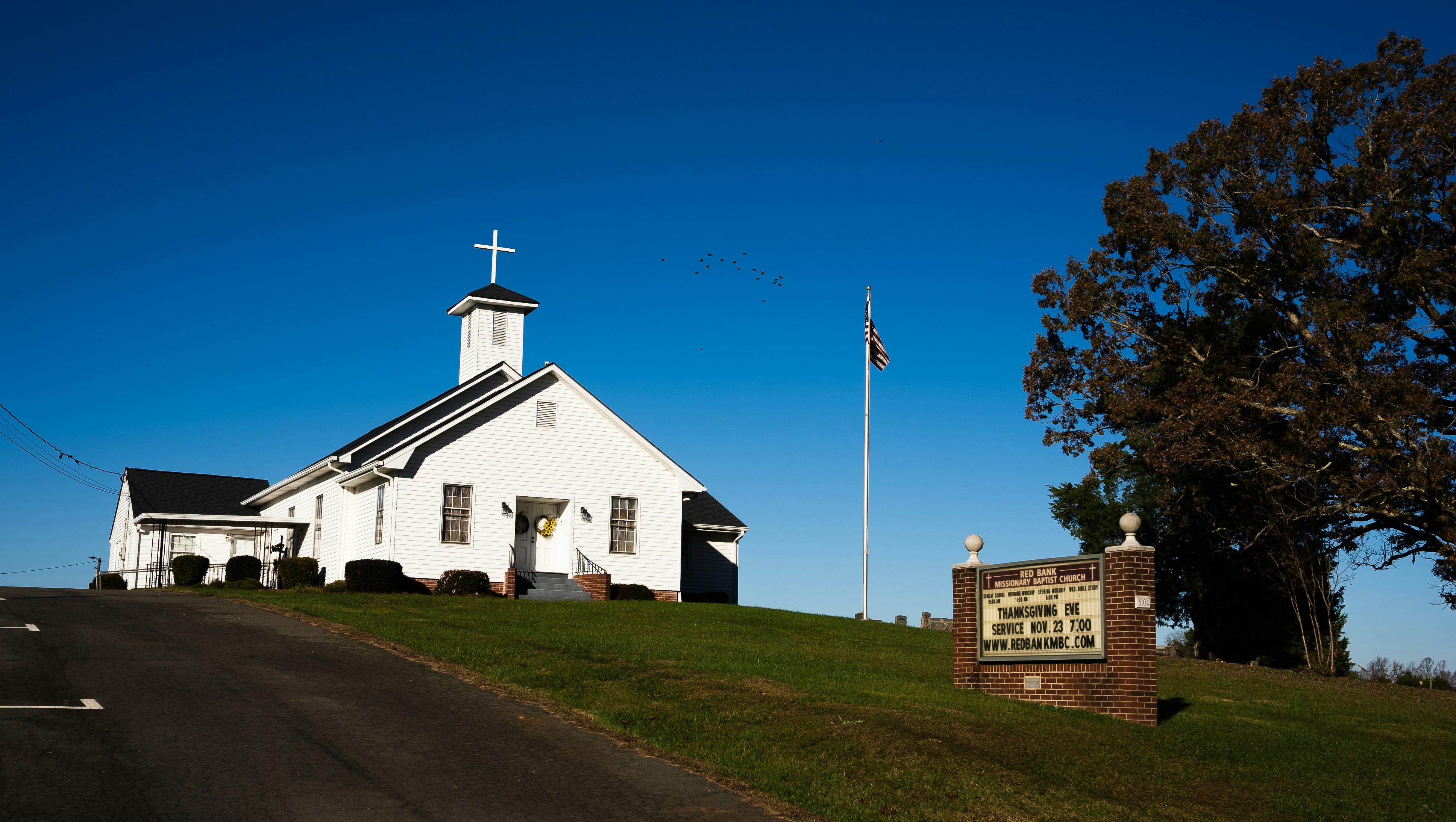 a white building with a cross on top